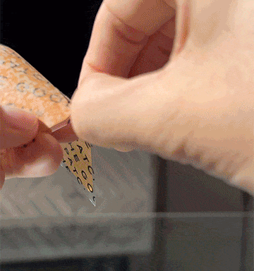Peeling a wellness patch and applying it to the inner wrist